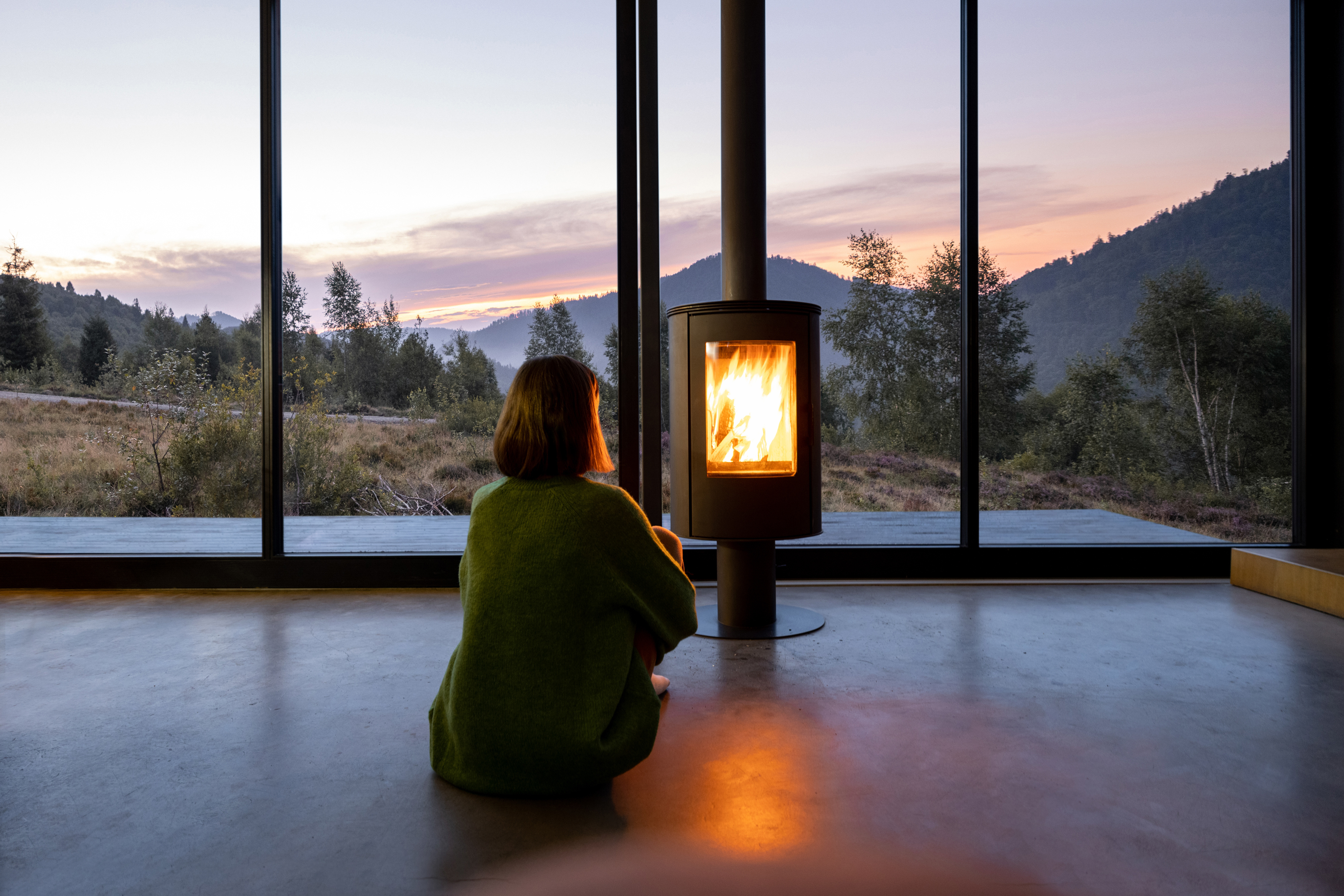 woman sitting in front of a fireplace