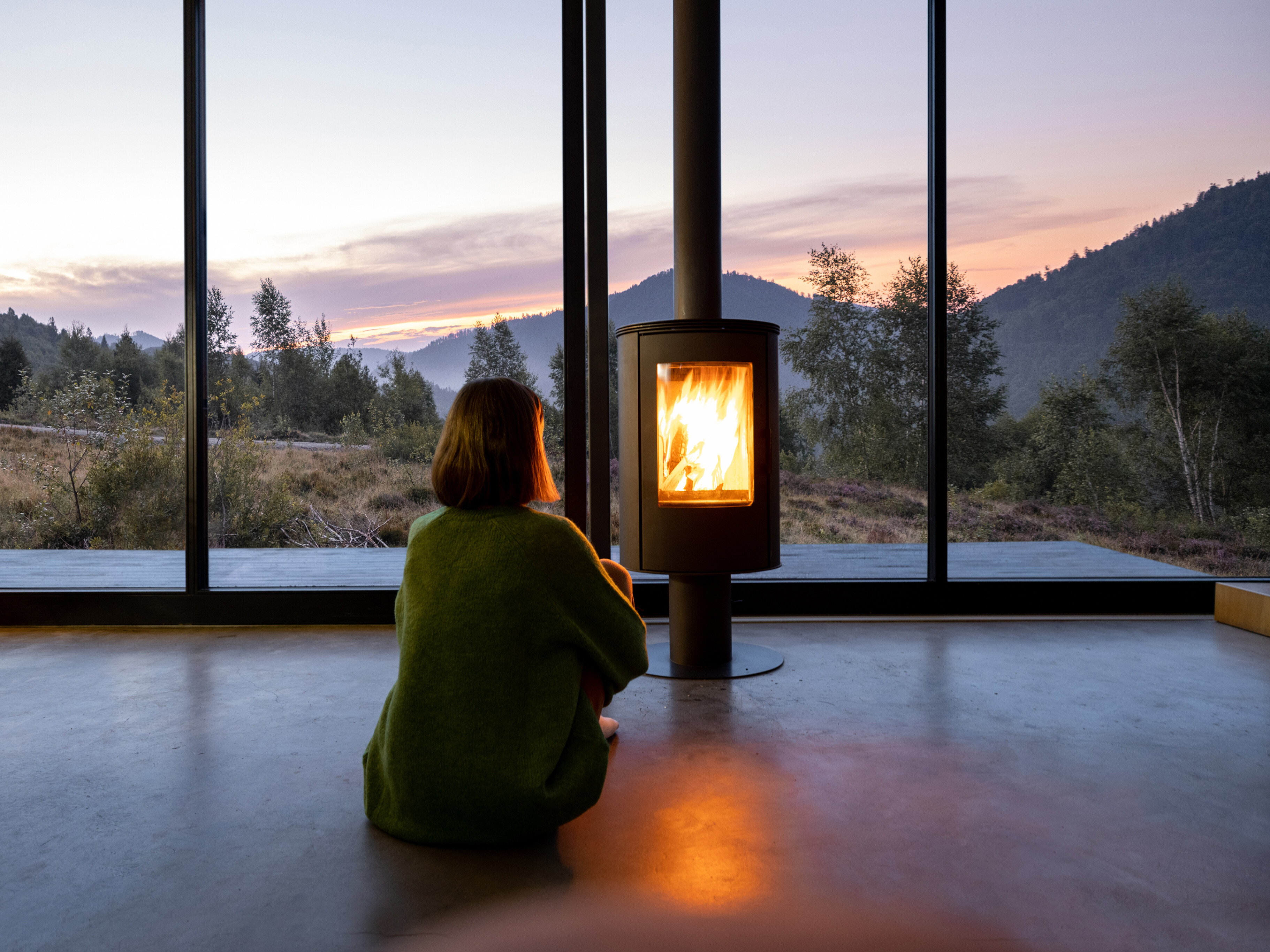 woman sitting in front of a fireplace