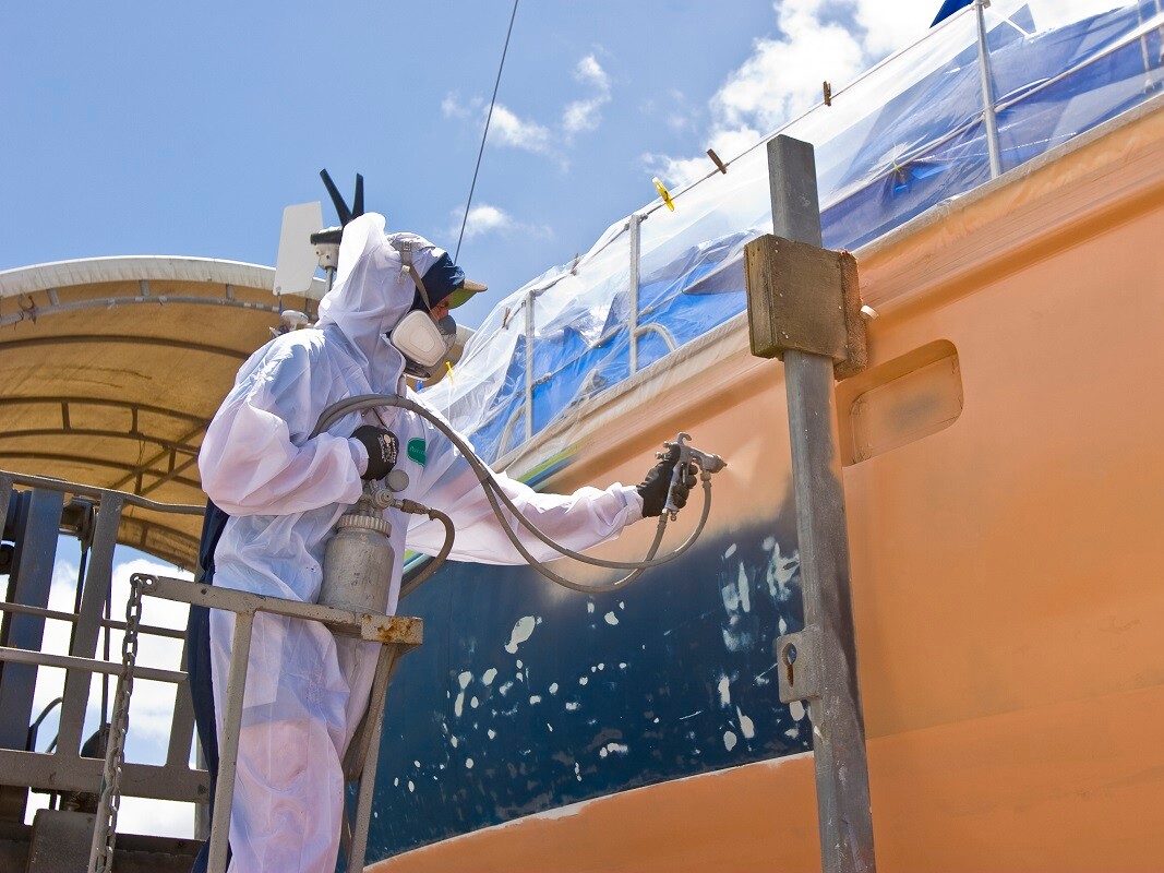 Man spraying a boat