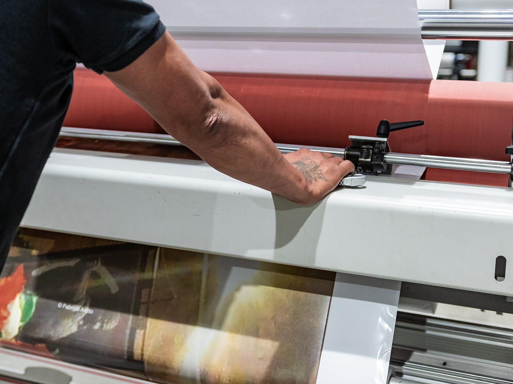 Hand of man on a industrial printer